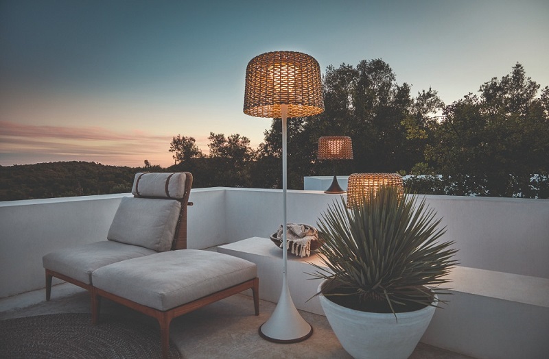 Solar rattan floor lamp on outdoor terrace