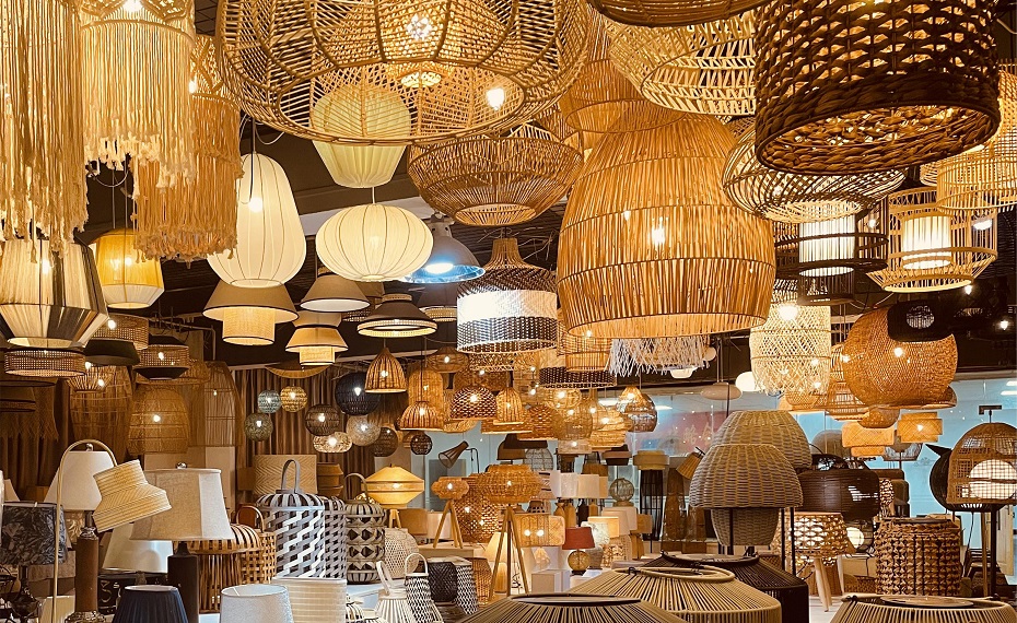 A professional rattan lighting showroom showing multiple handcrafted pendant lamps.