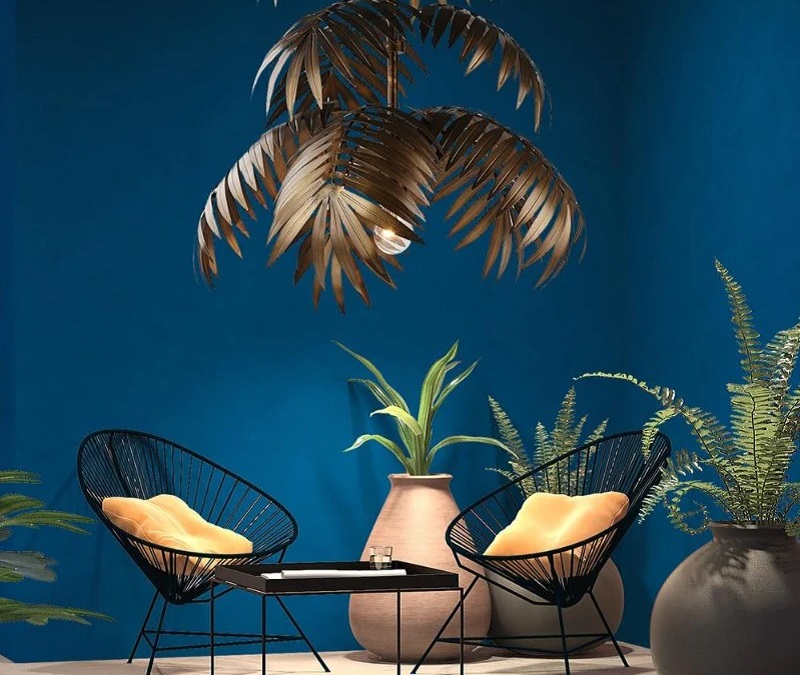 Palm pendant light surrounded by indoor plants