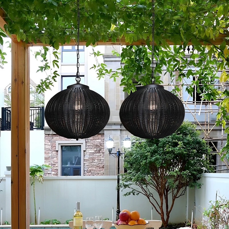 Outdoor seating area with synthetic-rattan pendant lights above a dining table