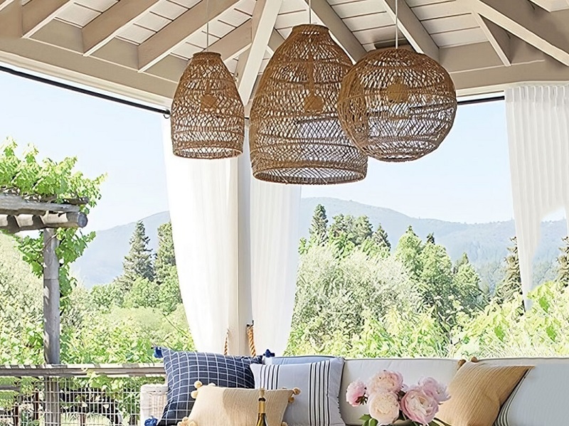 Woven rattan lamps hang beneath the covered gazebo
