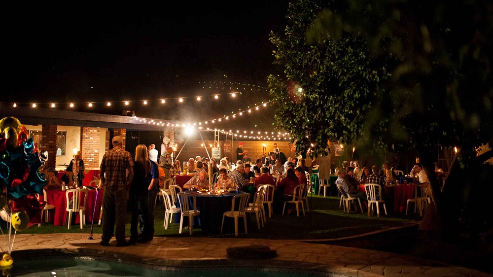 Outdoor lighting illuminates the party.